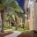 walking path framed with palm trees and buildings