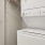 stacked washer/dryer unit in laundry closet