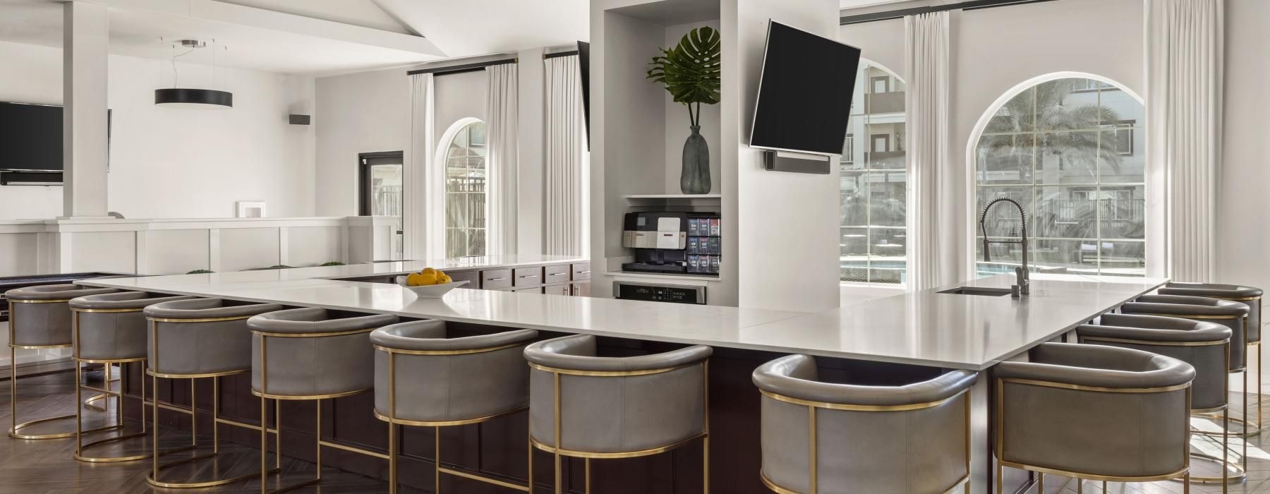 clubhouse kitchen with a bar and chairs
