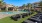 lawn of lounge chairs next to pool